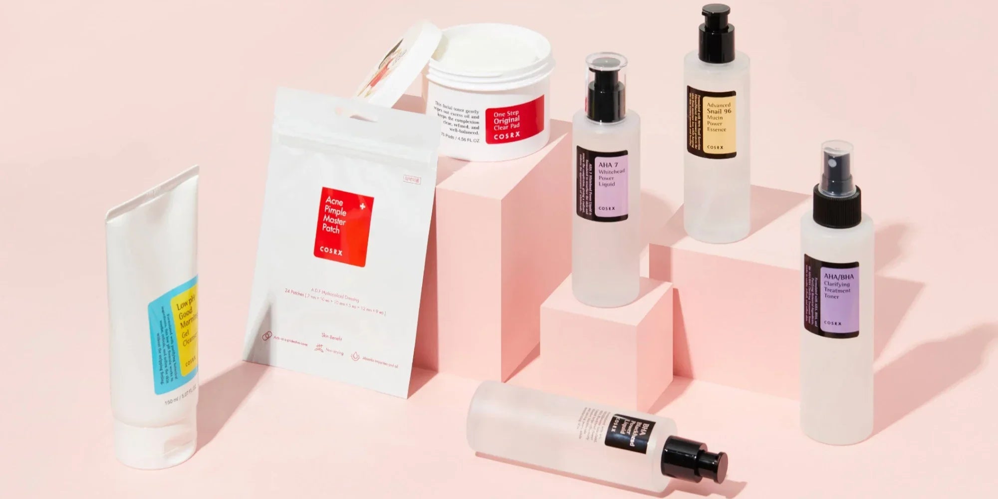 Cosrx skincare products displayed in a pink background