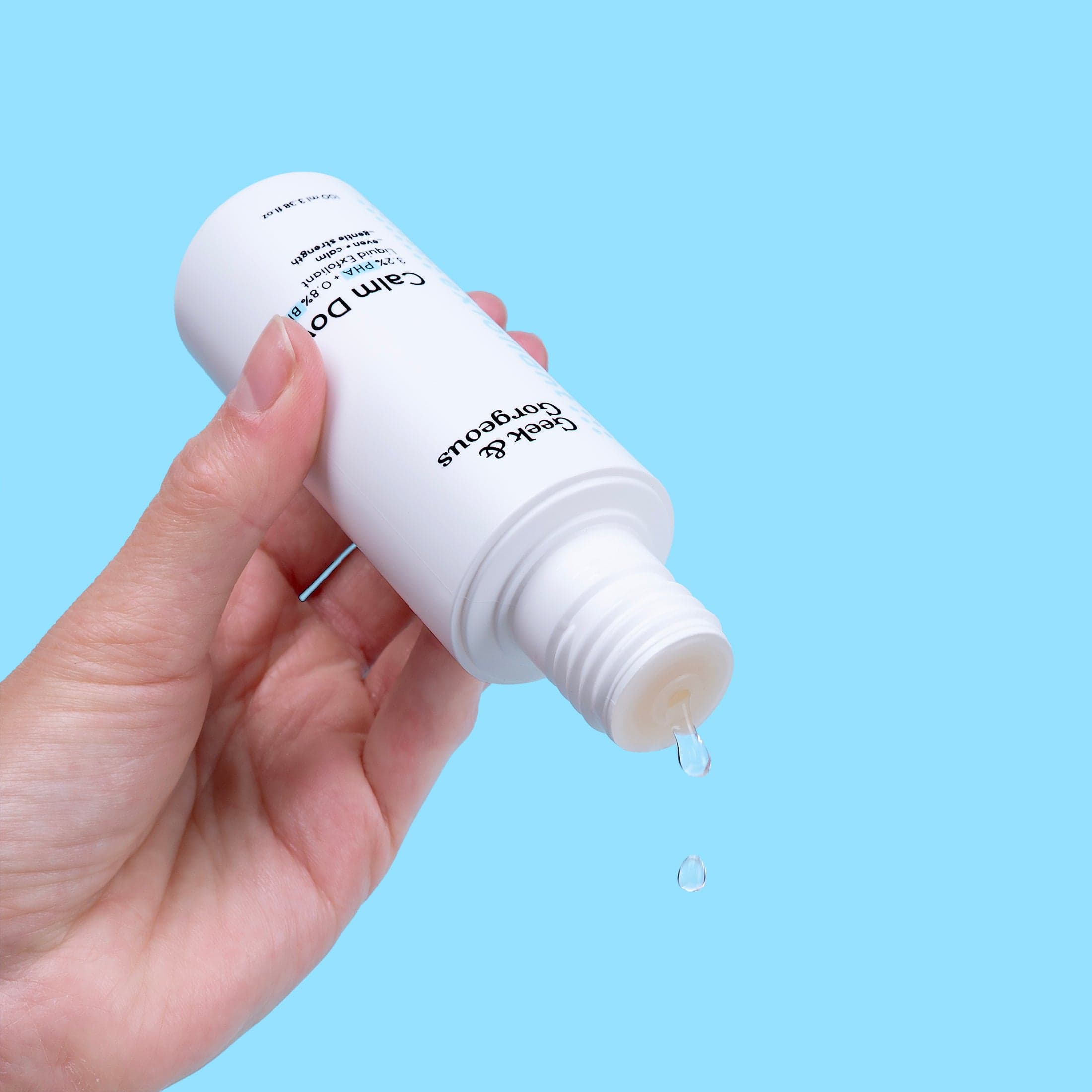 Geek & Gorgeous Calm Down Exfoliant Toner model holding bottle