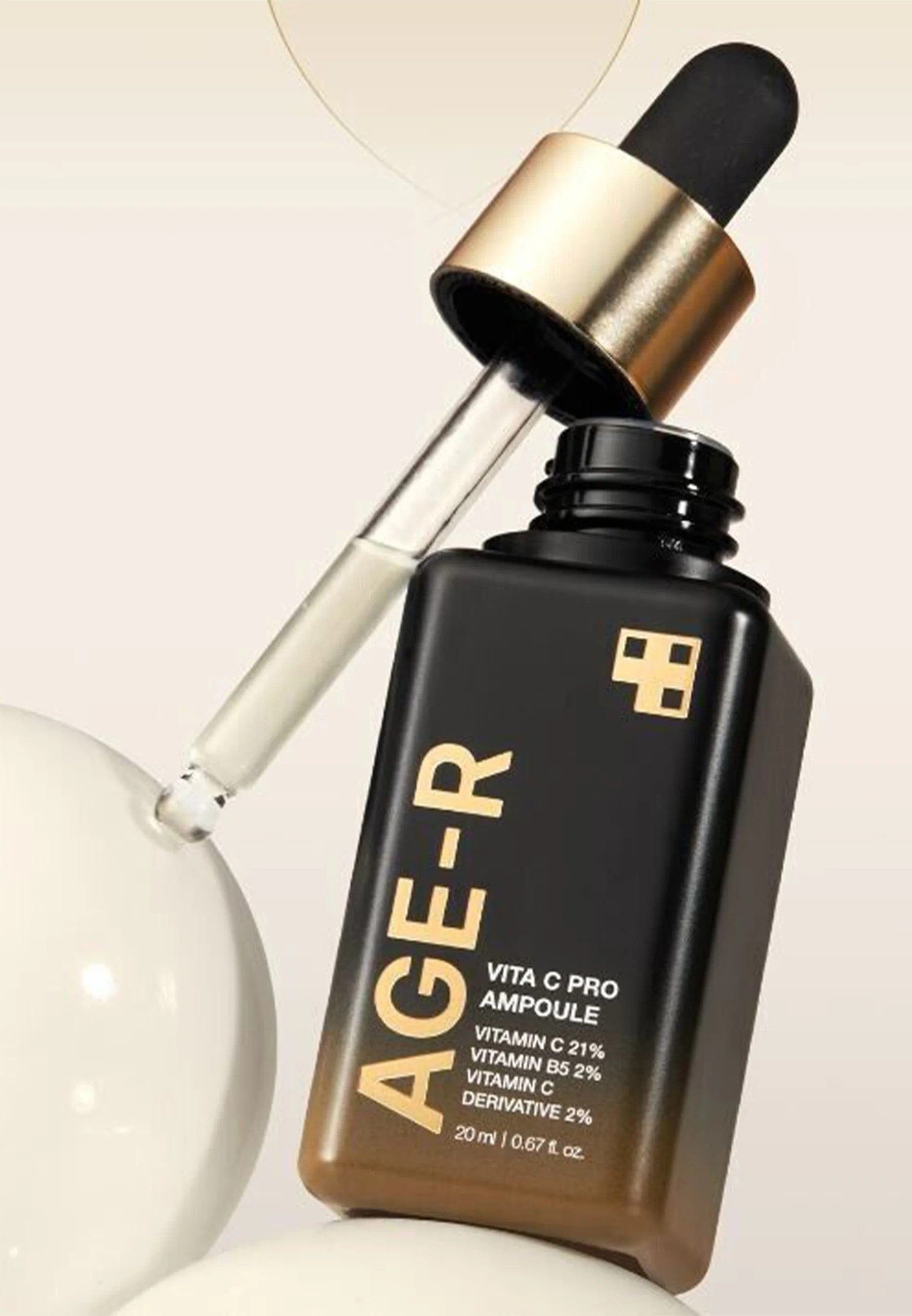 AGE-R skincare ampoule bottle with dropper on a light background